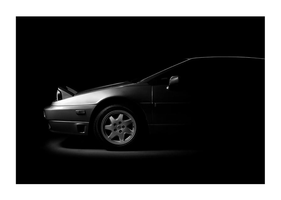 A Lotus Esprit shrouded in shadows exudes dramatic elegance.-12