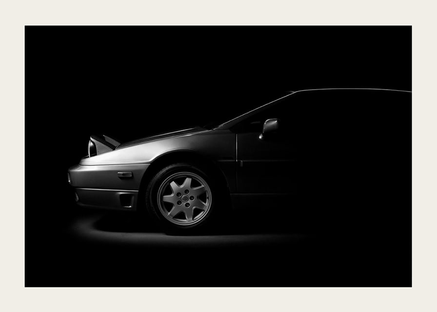 A Lotus Esprit shrouded in shadows exudes dramatic elegance.-12