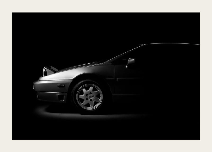A Lotus Esprit shrouded in shadows exudes dramatic elegance.-12