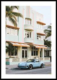 An iconic Porsche 911 in front of a pastel building creates nostalgia.-0