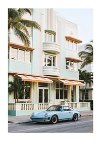 An iconic Porsche 911 in front of a pastel building creates nostalgia.-1