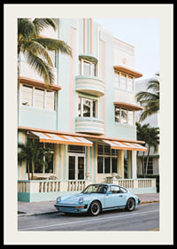 An iconic Porsche 911 in front of a pastel building creates nostalgia.-2