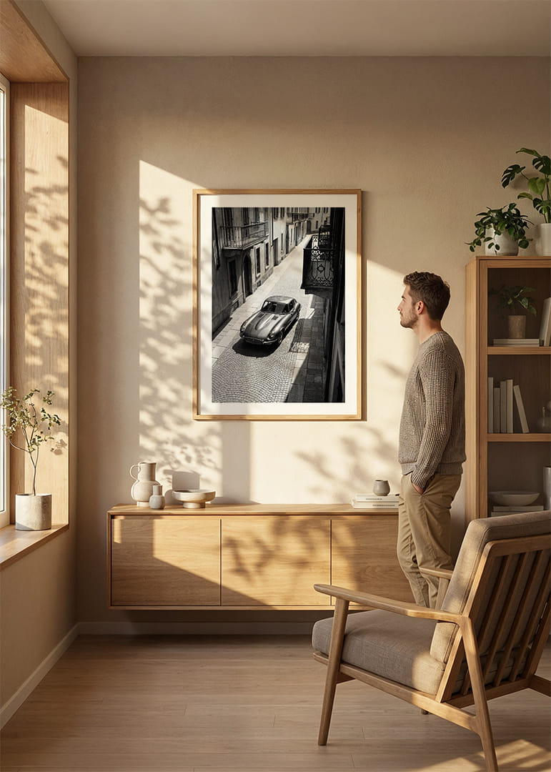 A classic Jaguar E-Type majestically stands on a sunlit cobblestone street.-12