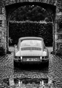 A classic Porsche 911 in a rainy landscape gives a nostalgic feeling.-3