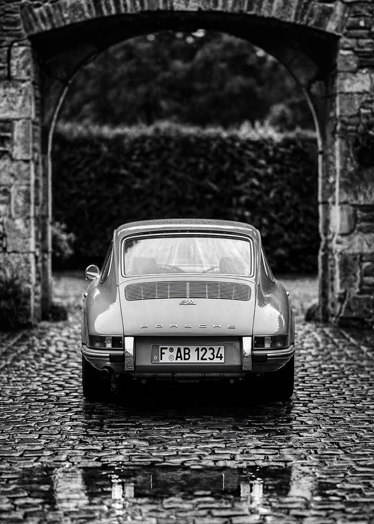 A classic Porsche 911 in a rainy landscape gives a nostalgic feeling.-12