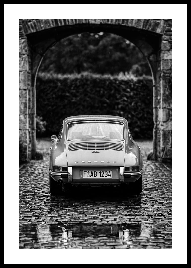 A classic Porsche 911 in a rainy landscape gives a nostalgic feeling.-12