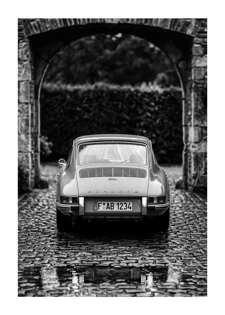 A classic Porsche 911 in a rainy landscape gives a nostalgic feeling.-12