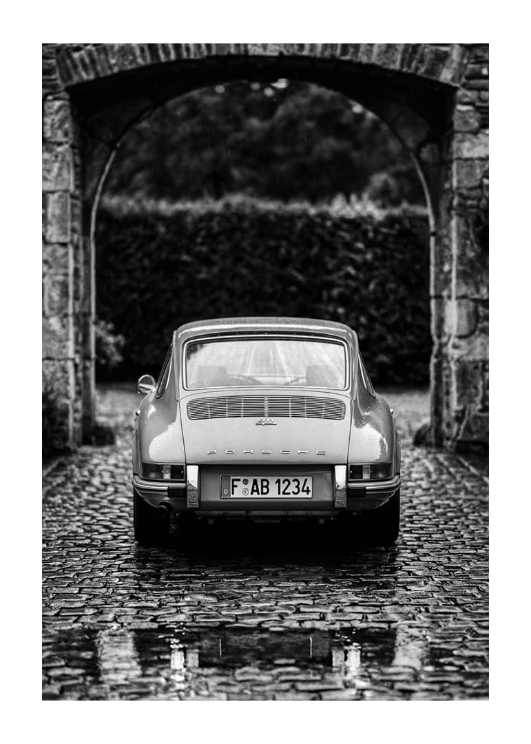 A classic Porsche 911 in a rainy landscape gives a nostalgic feeling.-12