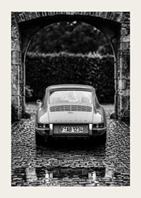 A classic Porsche 911 in a rainy landscape gives a nostalgic feeling.-3