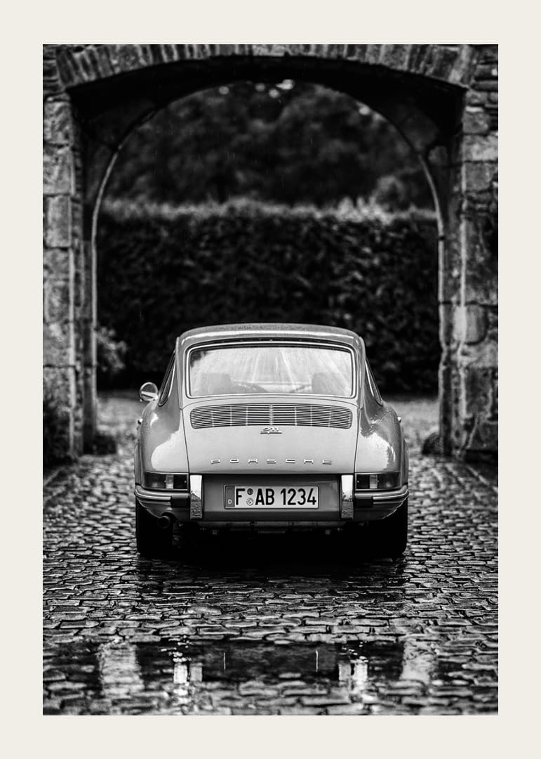 A classic Porsche 911 in a rainy landscape gives a nostalgic feeling.-12