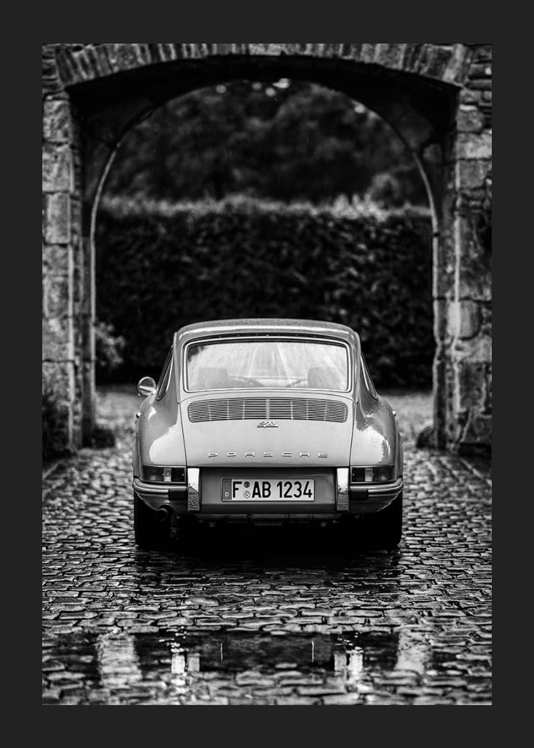 A classic Porsche 911 in a rainy landscape gives a nostalgic feeling.-12