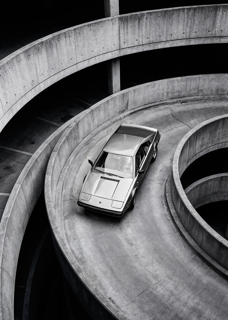 A Lamborghini Jalpa car sweeps through a spiraling concrete road in elegant style.-12