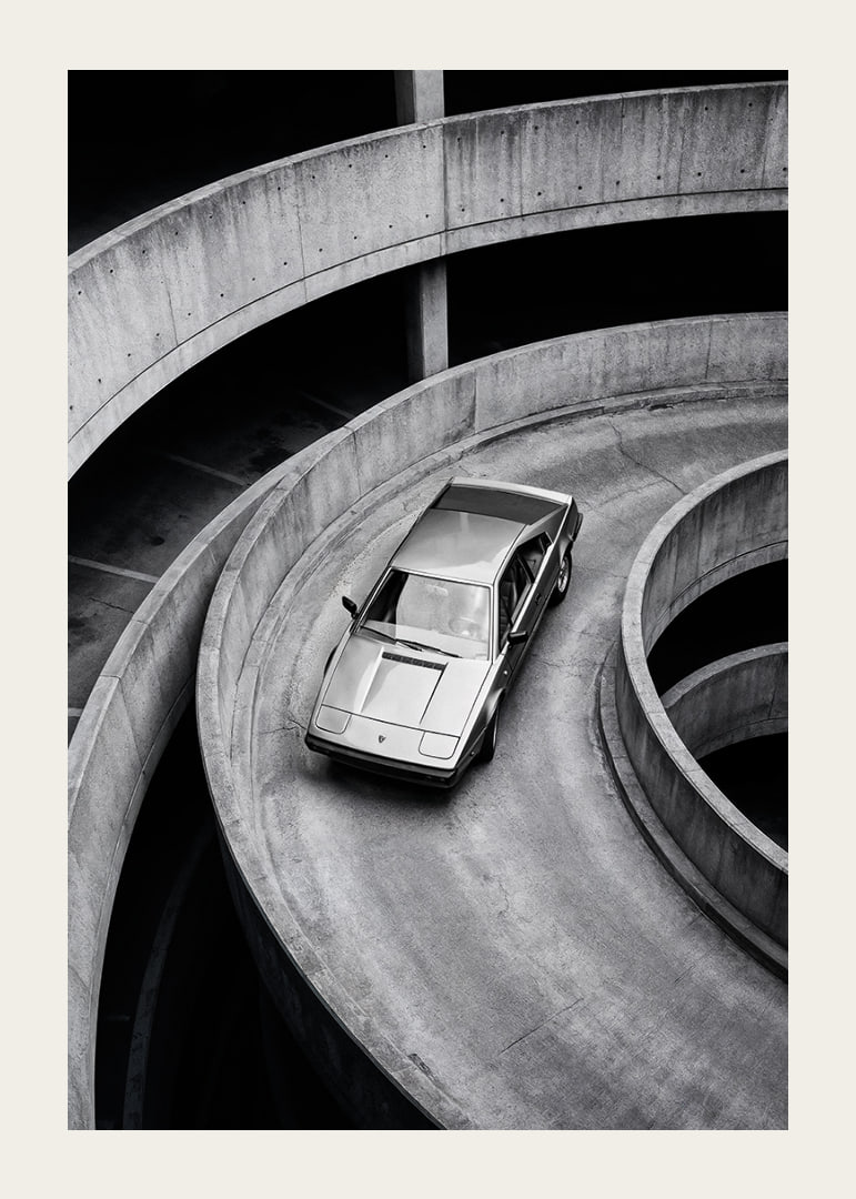 A Lamborghini Jalpa car sweeps through a spiraling concrete road in elegant style.-12