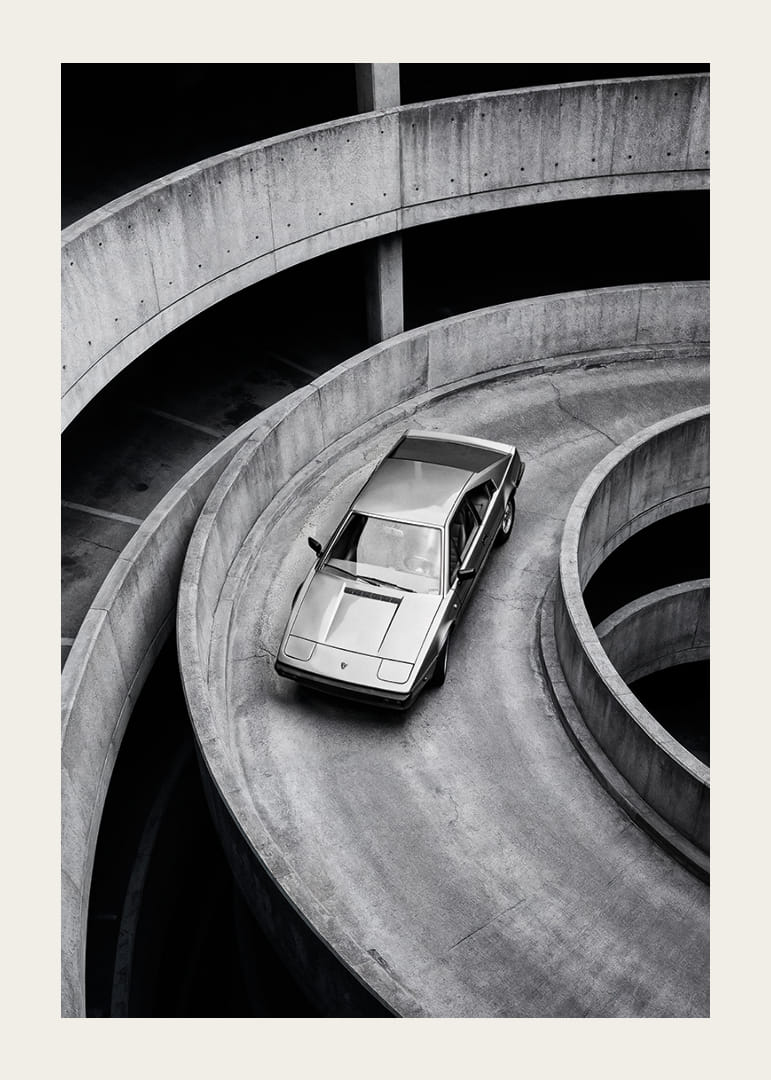 A Lamborghini Jalpa car sweeps through a spiraling concrete road in elegant style.-12
