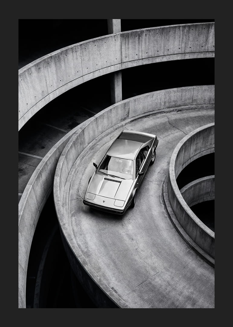A Lamborghini Jalpa car sweeps through a spiraling concrete road in elegant style.-12