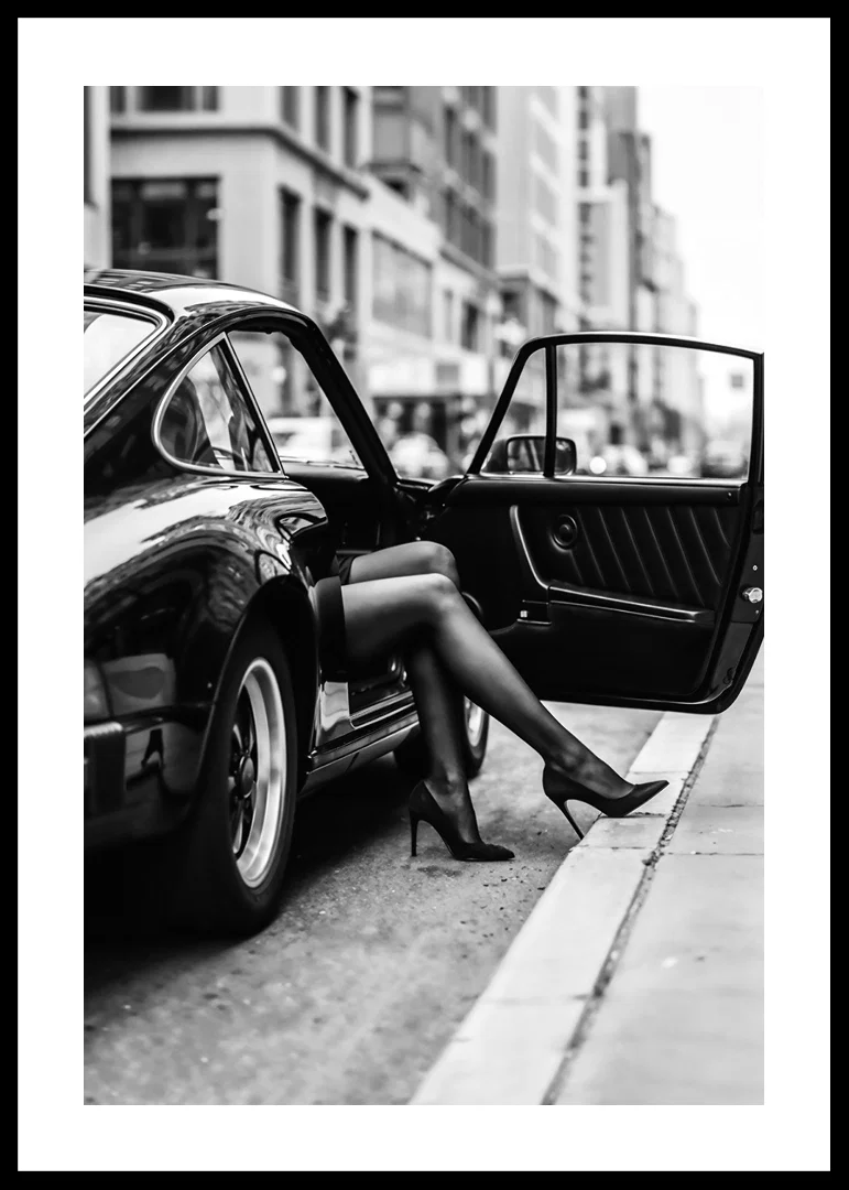 Elegant legs extend from a Porsche 911 in an urban setting.-12