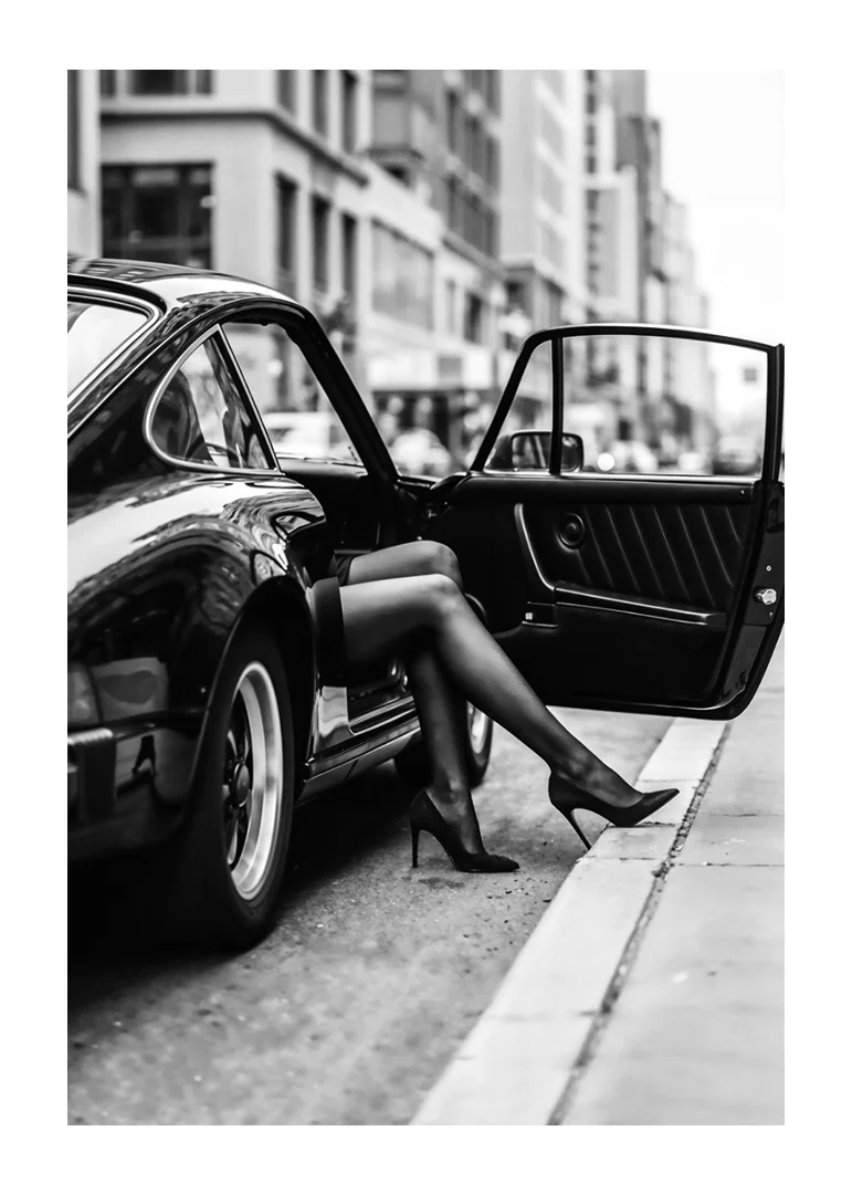Elegant legs extend from a Porsche 911 in an urban setting.-12