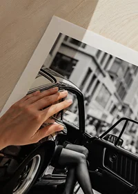 Elegant legs extend from a Porsche 911 in an urban setting.-9