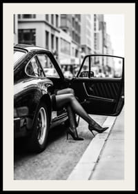 Elegant legs extend from a Porsche 911 in an urban setting.-2
