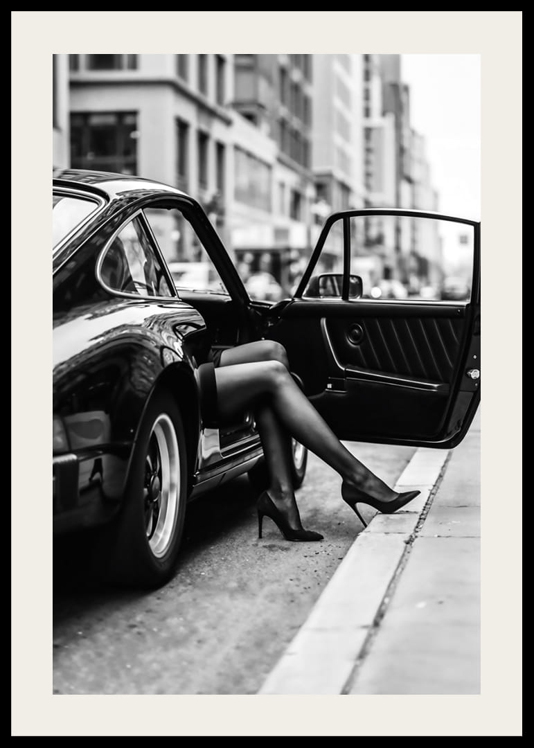 Elegant legs extend from a Porsche 911 in an urban setting.-12