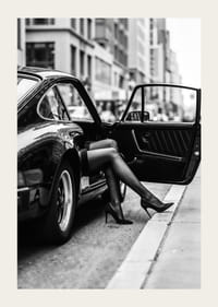 Elegant legs extend from a Porsche 911 in an urban setting.-3