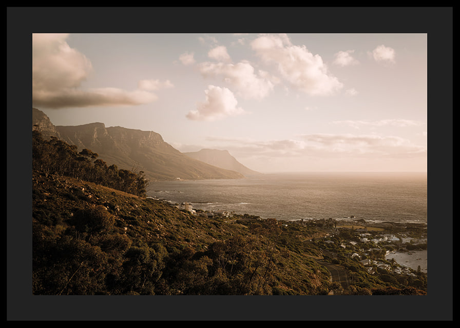 Soft clouds float over a peaceful coastline at sunset.-12