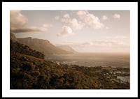 Soft clouds float over a peaceful coastline at sunset.-2