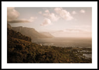Soft clouds float over a peaceful coastline at sunset.-2