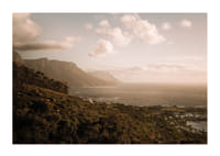 Soft clouds float over a peaceful coastline at sunset.-3