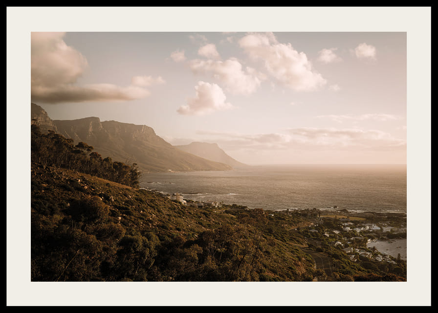 Soft clouds float over a peaceful coastline at sunset.-12