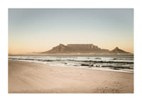 Tranquil coastline with a majestic mountain at sunset.-3