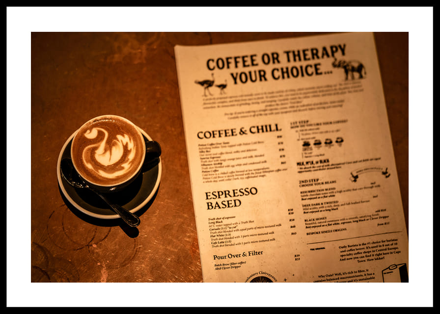 A hot cup of coffee alongside an engaging menu selection.-12