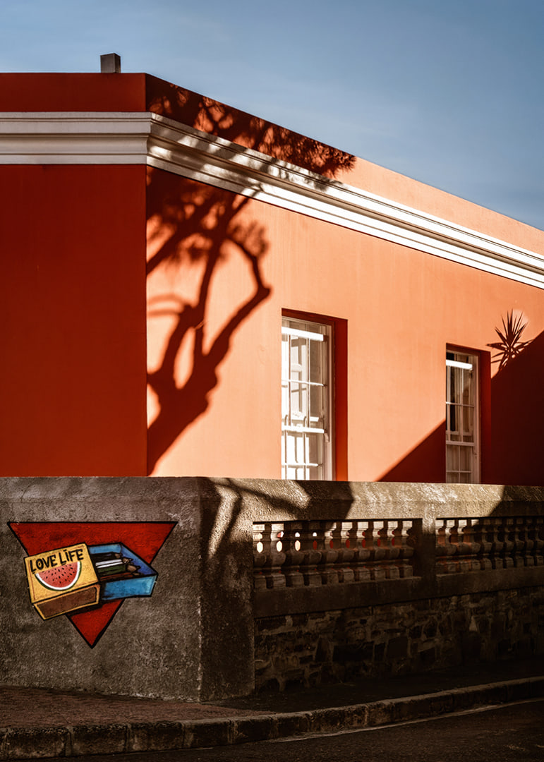 The sun's shadow play creates life on a colorful facade.-12