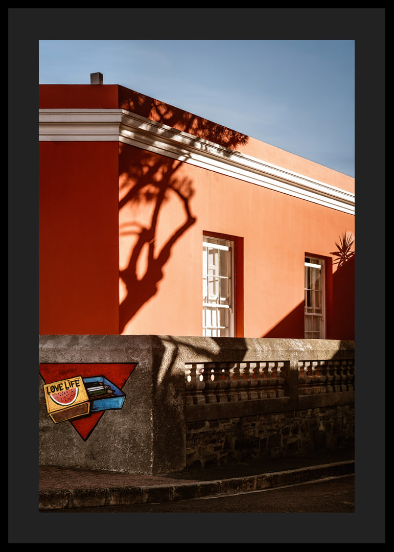 The sun's shadow play creates life on a colorful facade.-12