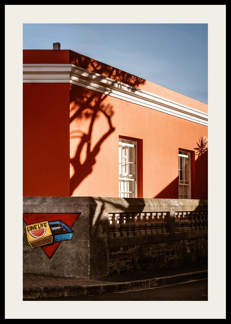 The sun's shadow play creates life on a colorful facade.-12