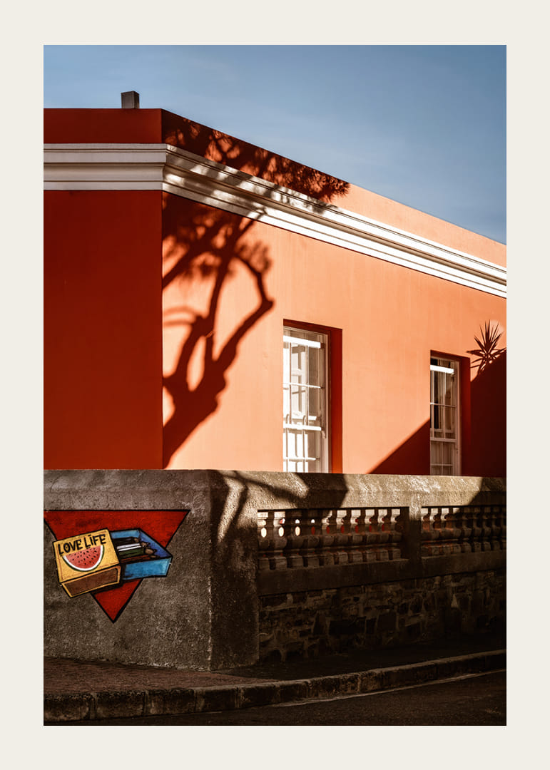 The sun's shadow play creates life on a colorful facade.-12