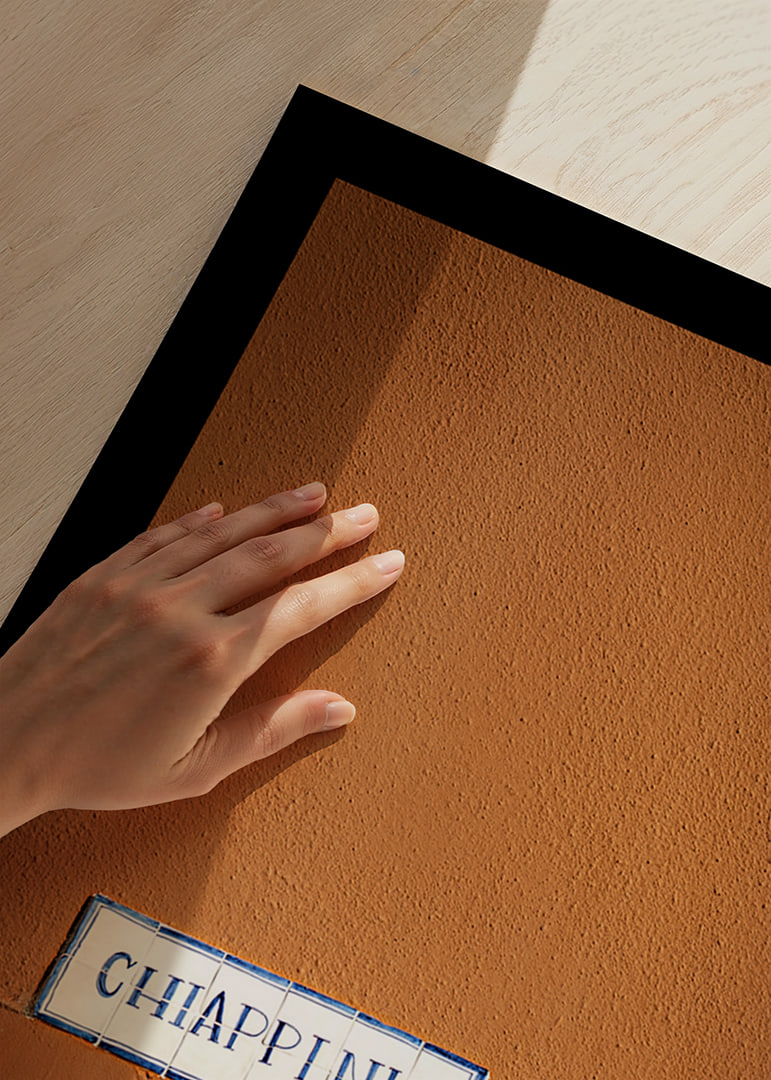 Warm terracotta-colored wall element with stylish street name.-12