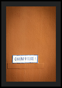Warm terracotta-colored wall element with stylish street name.-0