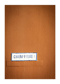 Warm terracotta-colored wall element with stylish street name.-3