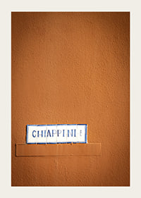 Warm terracotta-colored wall element with stylish street name.-5