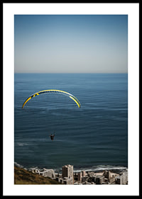 A paraglider soars majestically over the sea and the city.-2