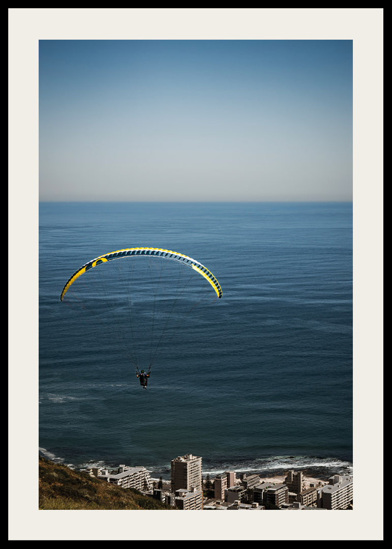 A paraglider soars majestically over the sea and the city.-12