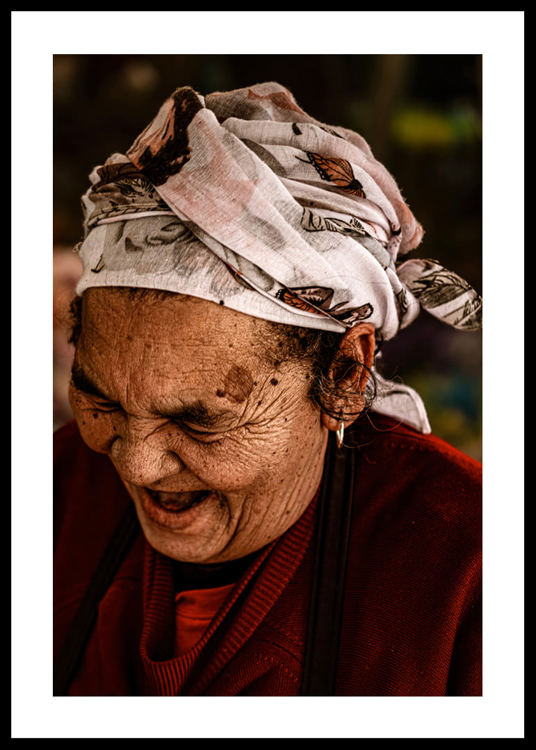 An elderly woman smiles in a warm, rustic atmosphere.-12