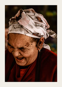 An elderly woman smiles in a warm, rustic atmosphere.-5
