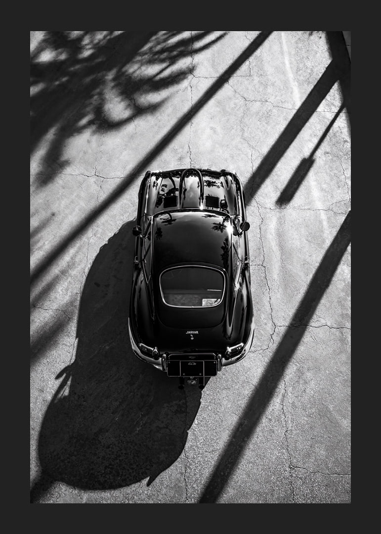 A classic Jaguar E-Type captured in the shade of tall palm trees-12