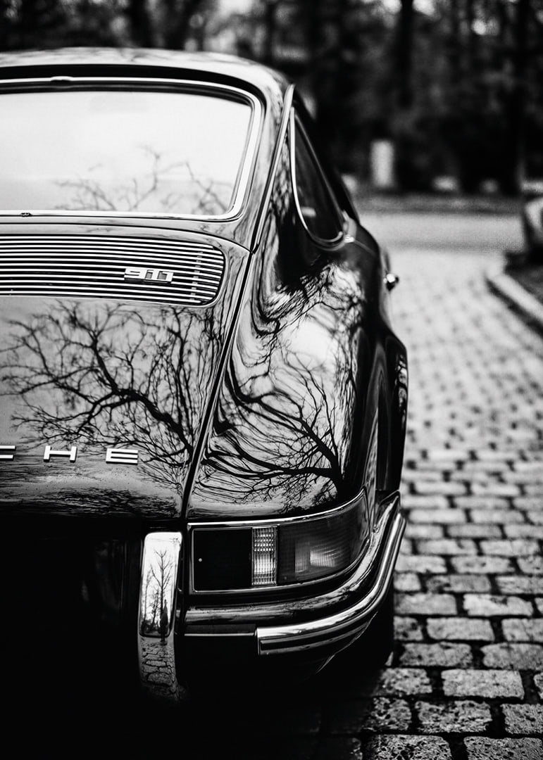 En klassisk Porsche 911 skapar en nostalgisk känsla på kullerstensgatan.-12