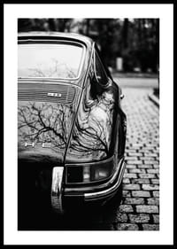 Klasisks Porsche 911 rada nostalģisku sajūtu uz bruģakmens ielas.-0