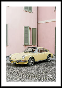 A charming pastel yellow Porsche 911 in front of a pink wall gives a retro feel.-0