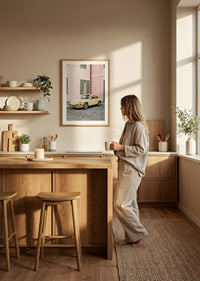 A charming pastel yellow Porsche 911 in front of a pink wall gives a retro feel.-8