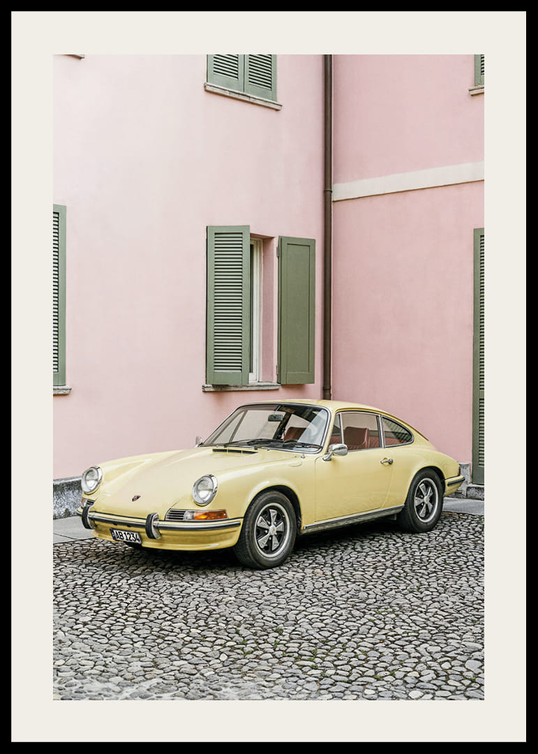 A charming pastel yellow Porsche 911 in front of a pink wall gives a retro feel.-12